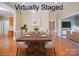 Bright dining room with hardwood floors and large windows. Features a wooden table set for six with tufted chairs at 4026 Saint James Way # 1, Monroe, NC 28110