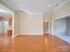 Open-concept living room with hardwood floors, neutral walls, and large windows offering plenty of natural light at 4026 Saint James Way # 1, Monroe, NC 28110