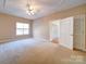 Large main bedroom includes a window, tray ceiling, and closet/bathroom access at 4026 Saint James Way # 1, Monroe, NC 28110