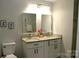 Bathroom featuring double vanity, granite countertop, modern fixtures and framed mirrors at 407 Talleyrand E St, Monroe, NC 28112