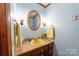 Powder room with a yellow pedestal sink and wood vanity at 4816 Zion Church Rd, Concord, NC 28025