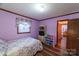 Light purple bedroom with a bed and built-in shelving at 4816 Zion Church Rd, Concord, NC 28025