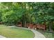 Inviting outdoor deck and seating area nestled amongst a large yard and trees at 4816 Zion Church Rd, Concord, NC 28025