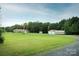 Well-maintained property with a long driveway, a detached garage, and large grassy yard at 4816 Zion Church Rd, Concord, NC 28025
