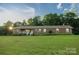 Charming one-story brick home featuring a well-maintained lawn and inviting front porch at 4816 Zion Church Rd, Concord, NC 28025