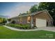 Charming brick home with a well-manicured lawn and a two-car garage at 4816 Zion Church Rd, Concord, NC 28025