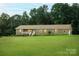 Brick home on a large lot with manicured landscaping and mature trees at 4816 Zion Church Rd, Concord, NC 28025