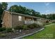 Low angle capturing the front of the home, featuring a charming brick exterior and landscaped garden at 4816 Zion Church Rd, Concord, NC 28025