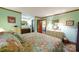 Main bedroom with floral bedding and en-suite bathroom access at 4816 Zion Church Rd, Concord, NC 28025