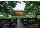 Back view of a well-maintained yard, featuring a sunroom and deck at 4816 Zion Church Rd, Concord, NC 28025