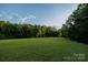Expansive lush green field surrounded by trees at 4816 Zion Church Rd, Concord, NC 28025