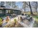 Great backyard with dining and sitting areas, a grill, and mature trees at 4833 Addison Dr, Charlotte, NC 28211