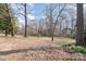 A serene backyard featuring a mix of mature trees and open space, perfect for outdoor relaxation at 4833 Addison Dr, Charlotte, NC 28211