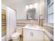 Clean bathroom with yellow and gray tiling, a tub-shower combo, and a white vanity at 4833 Addison Dr, Charlotte, NC 28211