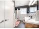 Modern bathroom features a wood vanity, tub with shower, and dark gray accent wall at 4833 Addison Dr, Charlotte, NC 28211