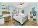 Comfortable bedroom with hardwood floors, a ceiling fan, a double window, and a cozy desk area at 4833 Addison Dr, Charlotte, NC 28211