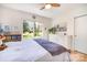Bedroom with ceiling fan, large window with natural light, and hardwood floors at 4833 Addison Dr, Charlotte, NC 28211