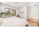 Bright bedroom featuring hardwood floors, light walls, neutral furniture and large windows overlooking the yard at 4833 Addison Dr, Charlotte, NC 28211
