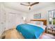 Bright bedroom with hardwood floors, a modern ceiling fan, lots of natural light, and a closet at 4833 Addison Dr, Charlotte, NC 28211