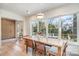 Bright dining area with large windows looking out onto the backyard and lovely hardwood floors at 4833 Addison Dr, Charlotte, NC 28211