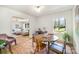 Bright dining area with a round table, vintage chairs, and an open view into the adjacent living room at 4833 Addison Dr, Charlotte, NC 28211