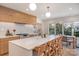 Open kitchen featuring a large island, seating, modern appliances, and a dining area by the windows at 4833 Addison Dr, Charlotte, NC 28211