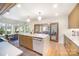 Bright kitchen with an island, wooden accents, and an adjacent dining area, and access to the living room at 4833 Addison Dr, Charlotte, NC 28211