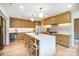 Open-concept kitchen with a large island, modern wooden cabinetry, pendant lighting, and bar stool seating at 4833 Addison Dr, Charlotte, NC 28211