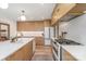Well-appointed kitchen featuring modern appliances, wooden cabinetry, a white countertop and hardwood floors at 4833 Addison Dr, Charlotte, NC 28211