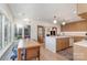 Bright kitchen and dining area with wood cabinets, island with sink, and breakfast bar open to the living room at 4833 Addison Dr, Charlotte, NC 28211