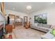 Bright open-concept living room and kitchen with fireplace, hardwood floors, and lots of seating at 4833 Addison Dr, Charlotte, NC 28211