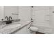 Modern bathroom featuring granite countertop, white cabinets, and shower-tub combo at 5177 Flay Rd, Lincolnton, NC 28021