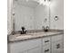 Bathroom vanity featuring granite countertops, dual undermount sinks, and modern black hardware at 5177 Flay Rd, Lincolnton, NC 28021