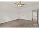 Neutral bedroom with ceiling fan, luxury vinyl plank flooring, and natural light at 5177 Flay Rd, Lincolnton, NC 28021