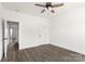 Bedroom featuring dark wood-look floors, white walls, doors, trim, and a modern ceiling fan at 5177 Flay Rd, Lincolnton, NC 28021