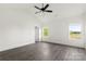 Spacious bedroom with dark wood-look floors, white walls, white trim, and two large windows at 5177 Flay Rd, Lincolnton, NC 28021