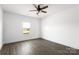 Bright bedroom featuring dark wood-look floors, white walls and trim, and a modern ceiling fan at 5177 Flay Rd, Lincolnton, NC 28021