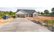 Gray siding and a dark roof make this exterior elevation pop, complete with a concrete driveway and an attached two-car garage at 5177 Flay Rd, Lincolnton, NC 28021