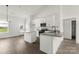Well-lit kitchen with a peninsula, white cabinets, and stainless appliances at 5177 Flay Rd, Lincolnton, NC 28021