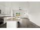 Bright kitchen with a granite-topped island and open layout to living area at 5177 Flay Rd, Lincolnton, NC 28021