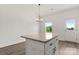 Kitchen island with granite countertop, stylish cabinetry, and views to backyard at 5177 Flay Rd, Lincolnton, NC 28021