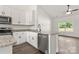 Modern kitchen with white cabinets, stainless steel dishwasher, granite countertops and hardwood floors, perfect for culinary enthusiasts at 5177 Flay Rd, Lincolnton, NC 28021