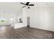 Open-concept living room and kitchen with white walls and wood-look floors at 5177 Flay Rd, Lincolnton, NC 28021