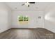 Inviting living room features hardwood floors, natural light streaming through the windows, and a welcoming entry door at 5177 Flay Rd, Lincolnton, NC 28021