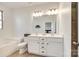 Bright bathroom featuring double vanity sinks, a large mirror, and a soaking tub for a luxurious experience at 5373 Orchid Bloom Dr, Fort Mill, SC 29707