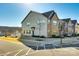 View of a multi-story townhome featuring brick and siding accents, complemented by well-maintained landscaping at 5373 Orchid Bloom Dr, Indian Land, SC 29707