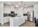 Well-lit kitchen featuring stainless steel appliances, modern cabinetry, and a spacious center island at 5373 Orchid Bloom Dr, Indian Land, SC 29707