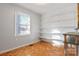 Well-lit bedroom with hardwood floors and built-in shelving at 5584 Valley Field Rd, Hickory, NC 28602