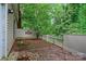 View of the backyard featuring partial fencing, a patio, and mature landscaping at 5929 Quail Hollow Rd # B, Charlotte, NC 28210