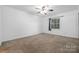 Neutral bedroom with a ceiling fan, window, and plush carpeting for a comfortable feel at 5929 Quail Hollow Rd # B, Charlotte, NC 28210